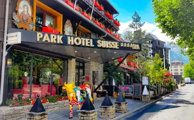 a group of women sitting at a table with food and mountains at Park Hotel Suisse & Spa in Chamonix-Mont-Blanc