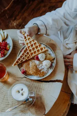 a table with a waffle and a plate of food at M de Megève in Megève