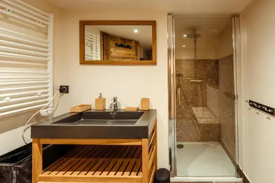 a bathroom with a black sink and a shower at Chalet du Rachet Chamonix Mont-Blanc in Les Houches