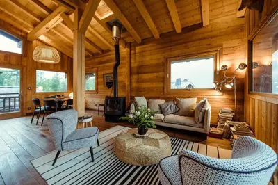 a living room with a couch and chairs and a table at Chalet du Rachet Chamonix Mont-Blanc in Les Houches