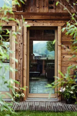 a door to a wooden house with a porch at Chalet du Rachet Chamonix Mont-Blanc in Les Houches