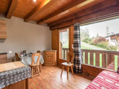 a kitchen with wooden cabinets and a sink at Studio Les G'rets-10 by Interhome in Saint-Gervais-les-Bains