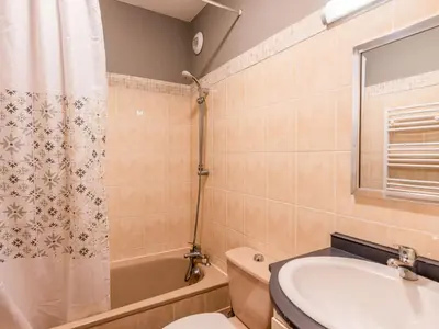 a room with a bed with red and white blankets at Studio Les G'rets-10 by Interhome in Saint-Gervais-les-Bains