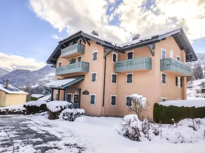 a green lawn with mountains in the background at Apartment Le Parc du Mont Joly-2 by Interhome in Saint-Gervais-les-Bains