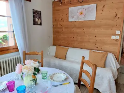 a dining room with a table and a couch at Apartment A la Claire Fontaine 1 by Interhome in Mémontel