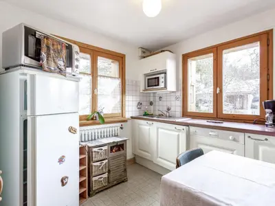a kitchen with white cabinets and a white refrigerator at Apartment A la Claire Fontaine 1 by Interhome in Mémontel