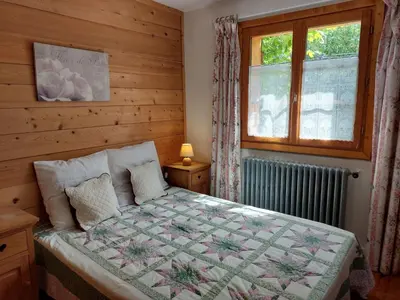 a bedroom with a bed with a quilt on it at Apartment A la Claire Fontaine 1 by Interhome in Mémontel