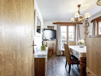 a dining room with a table and a television at Apartment A la Claire Fontaine 1 by Interhome in Mémontel