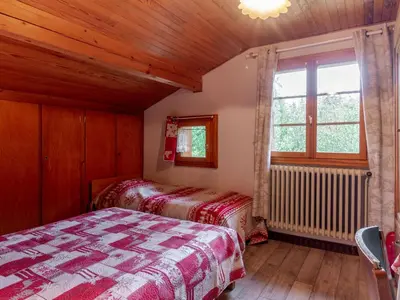 a bedroom with two beds and a window at Apartment A la Claire Fontaine 2 by Interhome in Mémontel