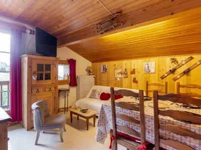 a bedroom with a bed and a table and a chair at Apartment A la Claire Fontaine 2 by Interhome in Mémontel