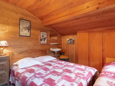 a bedroom with a bed in a wooden cabin at Apartment A la Claire Fontaine 2 by Interhome in Mémontel