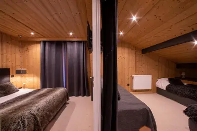 a bedroom with two beds and a window at Chalet-Hôtel Les Rhodos in Cordon