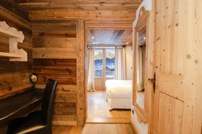 a wooden cabin with a window and a refrigerator in it at Chalet-Hôtel Hermitage in Chamonix-Mont-Blanc