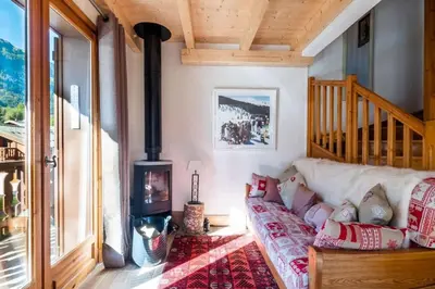 a living room with a couch and a wood stove at Glacier - Les Amethystes in Les Houches