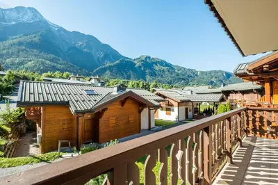 a balcony with a view of a village and mountains at Glacier - Les Amethystes in Les Houches