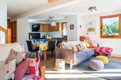 a living room with a couch and a dining room at Glacier - Les Amethystes in Les Houches