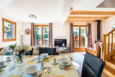 a living room with a table and chairs at Glacier - Les Amethystes in Les Houches