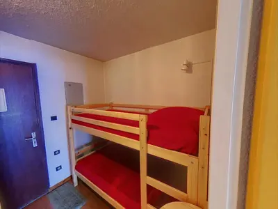 a bedroom with two bunk beds in a room at Studio 4 Pers (AM113) in Les Carroz d'Araches