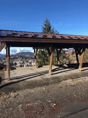a wooden picnic table sitting on the side of a road at AG005 - Studio coin montagne proche pistes in Les Carroz d'Araches