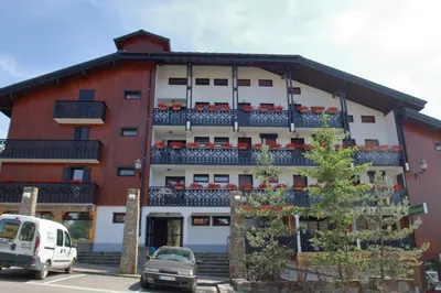 a building with balconies and cars parked in a parking lot at CA111 - Studio 4 pers centre des Carroz in Les Carroz d'Araches