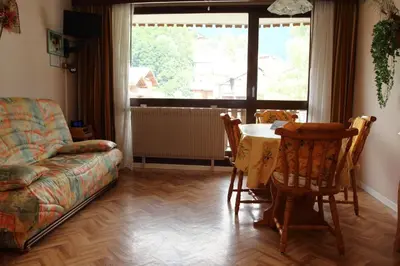 a living room with a couch and a table and chairs at CL349 - Studio 4 Pers centre des Carroz in Les Carroz d'Araches