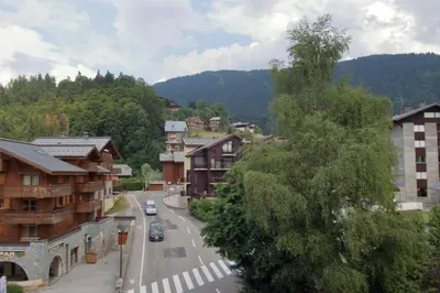 a street in a small town with buildings and trees at CL349 - Studio 4 Pers centre des Carroz in Les Carroz d'Araches