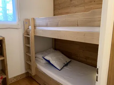 a couple of bunk beds in a room at CX116 - Duplex 6 pers Pied de pistes in Les Carroz d'Araches