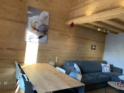 a living room with a table and a couch at CX116 - Duplex 6 pers Pied de pistes in Les Carroz d'Araches