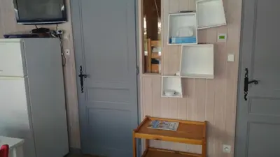 a room with a refrigerator and a table and a television at EA115 - 2 Pièces 6 Pers proche centre des Carroz in Les Carroz d'Araches