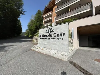 a sign in front of a building with a building at GCF211 appartement 6 pers pied de piste in Les Carroz d'Araches