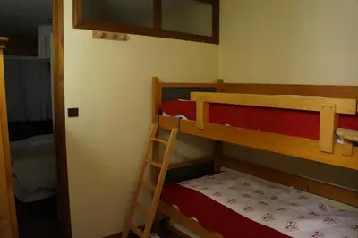 a bedroom with two bunk beds and a ladder at GR007 - 2 Pièces 5/6 pers centre Carroz in Les Carroz d'Araches