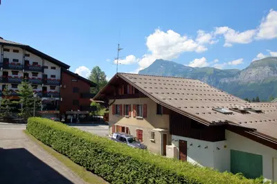 a building with a car parked in a parking lot at GR007 - 2 Pièces 5/6 pers centre Carroz in Les Carroz d'Araches