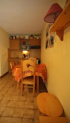 a kitchen with a table and a table and chairs at MA002 2 Pièces 4 Pers centre Carroz in Les Carroz d'Araches