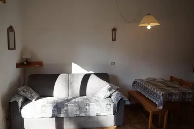 a living room with a couch and a table at NAN01 - Studio 4 Pers Télécabine in Les Carroz d'Araches