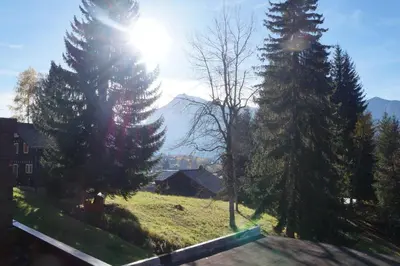 a view of a mountain from a house with trees at NAN01 - Studio 4 Pers Télécabine in Les Carroz d'Araches