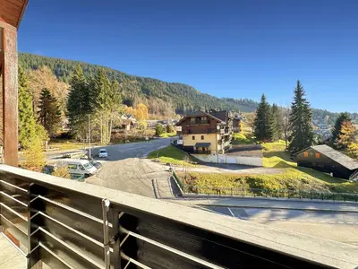 a balcony with a view of a road and houses at OB222 - 2 pièces Mezzanine 6 pers pieds de pistes in Les Carroz d'Araches