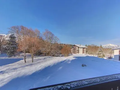 a yard covered in snow with a house in the background at OEI20 - Studio 4/5 Pers proche centre Carroz in Les Carroz d'Araches