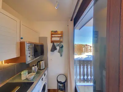 a small kitchen with a view of a balcony at OEI20 - Studio 4/5 Pers proche centre Carroz in Les Carroz d'Araches