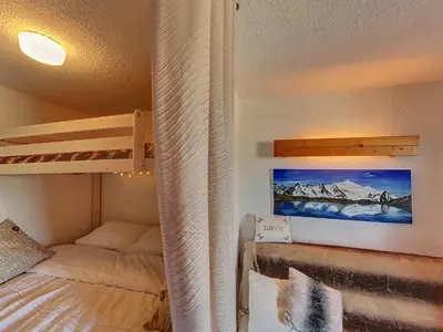 a bedroom with a bunk bed next to a bunk bed gmaxwell gmaxwell gmaxwell at OEI20 - Studio 4/5 Pers proche centre Carroz in Les Carroz d'Araches