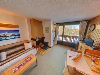 a living room with a couch and a television at OEI20 - Studio 4/5 Pers proche centre Carroz in Les Carroz d'Araches