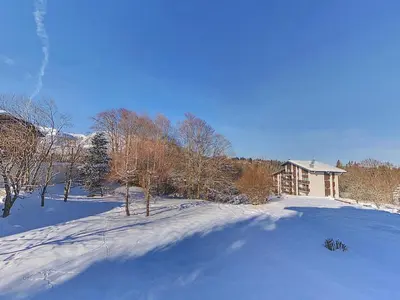 a snow covered yard with a house in the background at OEI20 - Studio 4/5 Pers proche centre Carroz in Les Carroz d'Araches