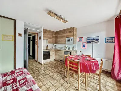 a kitchen and dining room with a table and chairs at RB111 - Studio 4 Pers centre Carroz in Les Carroz d'Araches