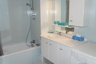 a white bathroom with a sink and a shower at SB106 - 2 Pièces 5/6 Pers centre des Carroz in Les Carroz d'Araches