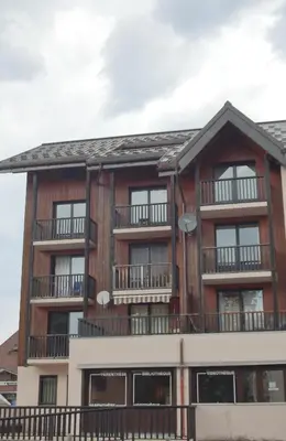 an apartment building with windows and balconies at SH104 - Studio 4 pers centre des Carroz in Les Carroz d'Araches