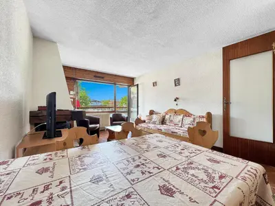 a bedroom with a bed and a television in a room at SL127 - 2 Pièces 4 Pers centre Carroz in Les Carroz d'Araches