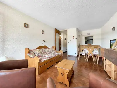 a living room with a couch and a table at SL127 - 2 Pièces 4 Pers centre Carroz in Les Carroz d'Araches