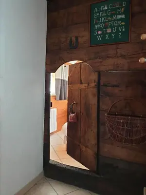 a mirror in a room with a door and a hallway at Le Bivouac in Chamonix-Mont-Blanc