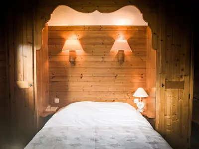 a bedroom with a bed with two lamps on it at Le Bivouac in Chamonix-Mont-Blanc
