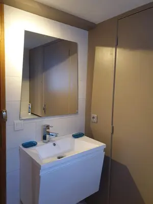 a bathroom with a white sink and a mirror at Le Bivouac in Chamonix-Mont-Blanc