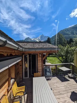 a wooden deck with a table and chairs on a house at Le Bivouac in Chamonix-Mont-Blanc